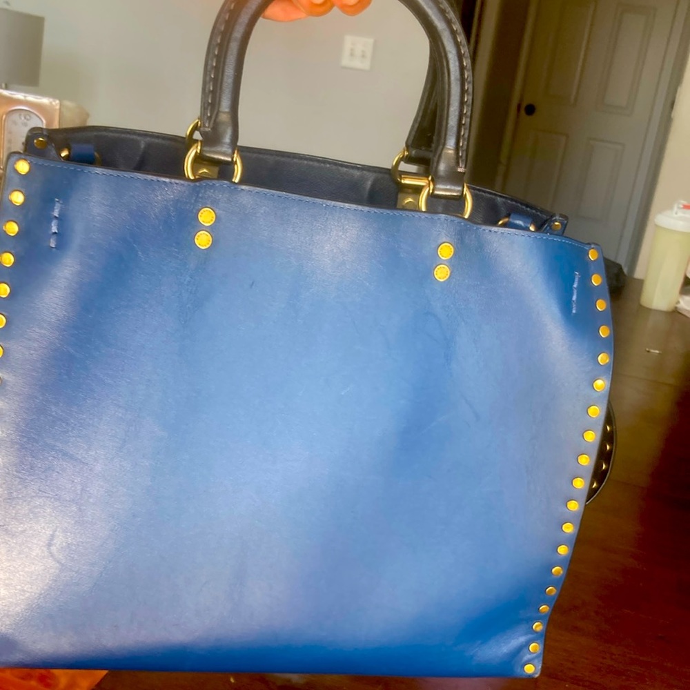 Blue leather Coach handbag, with brass rivets.